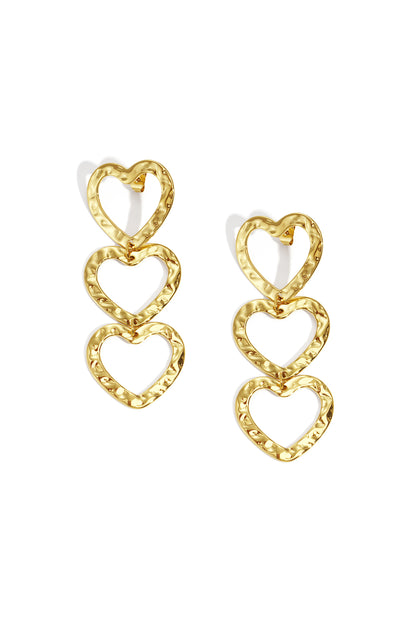 Gold-tone triple heart dangle earrings with hammered texture on white background