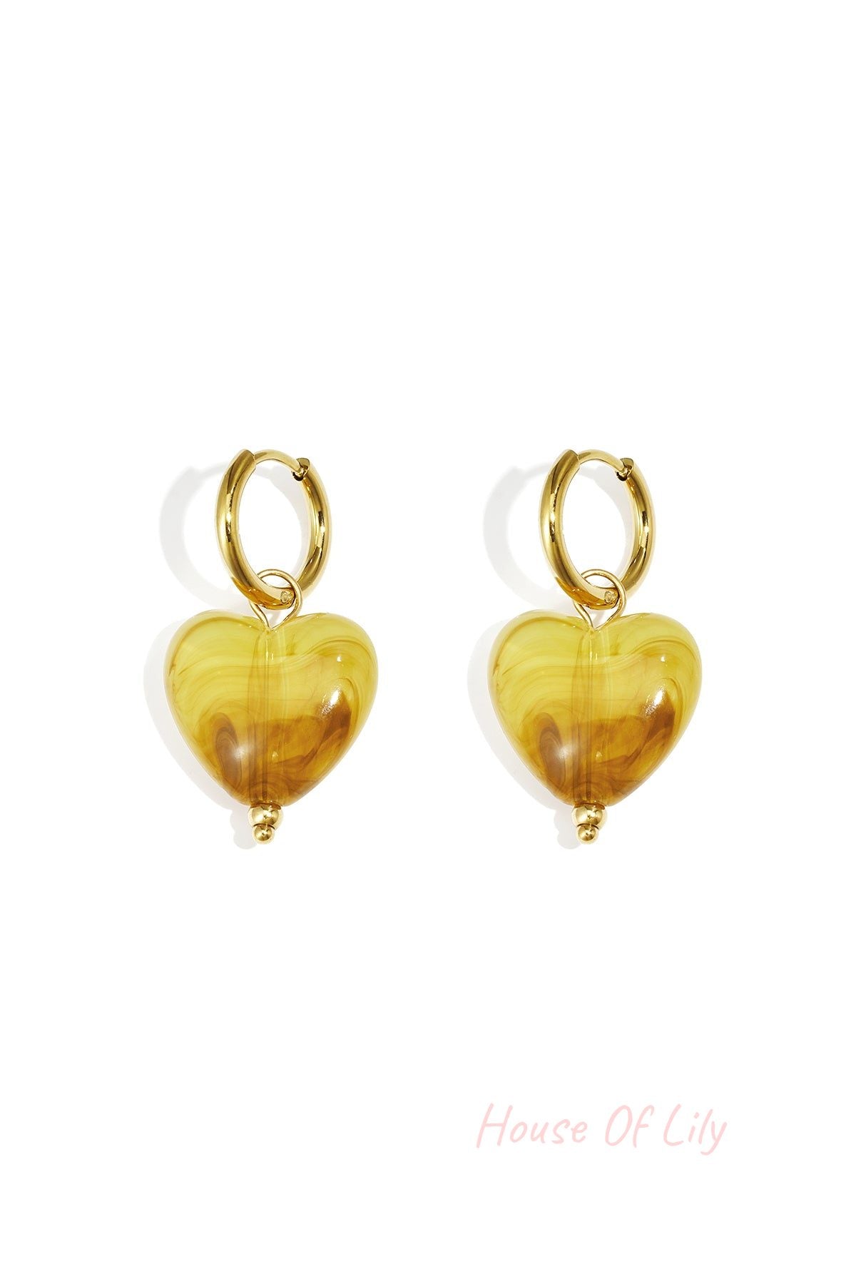 Pair of gold hoop earrings with peach glossy resin heart pendants on white background (different shade variant)