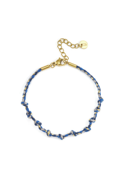Charmed Cotton Chain bracelet with blue and grey knotted threads, gold-tone metal accents, and an adjustable chain clasp.
