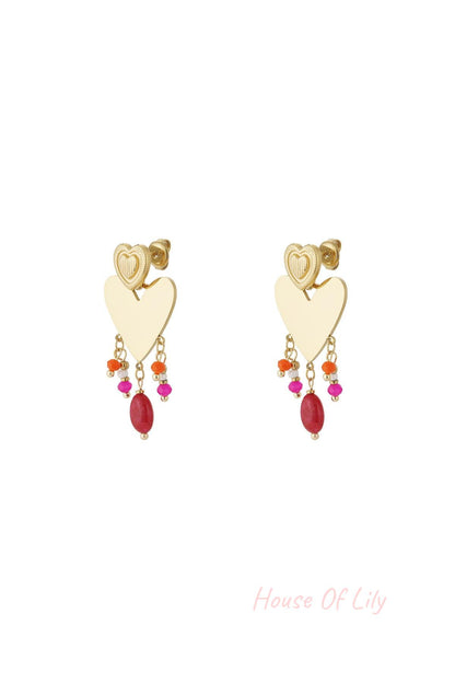 Pair of gold-tone heart drop earrings with colorful pink, orange, and red bead charms dangling below a textured smaller heart stud on white background.