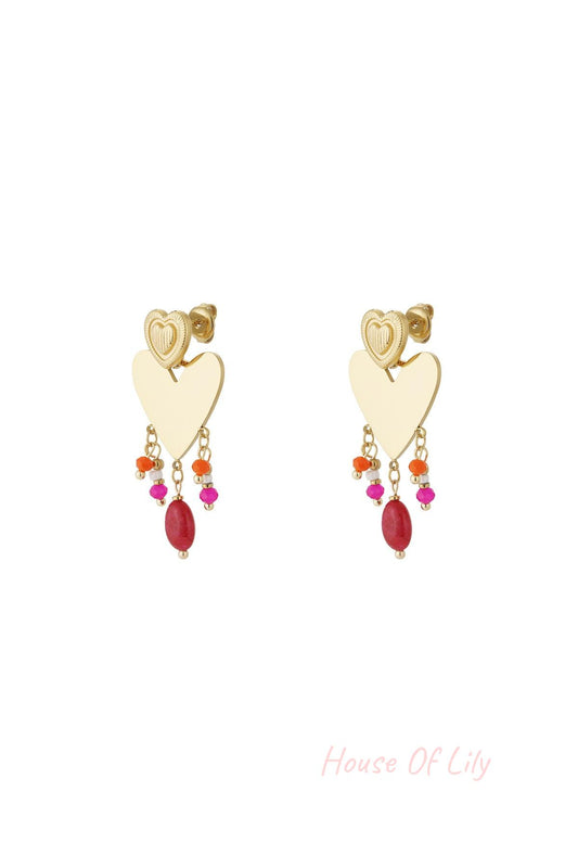 Pair of gold-tone heart drop earrings with colorful pink, orange, and red bead charms dangling below a textured smaller heart stud on white background.