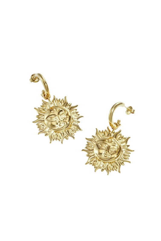 Pair of gold sun face drop earrings with detailed sun rays on white background