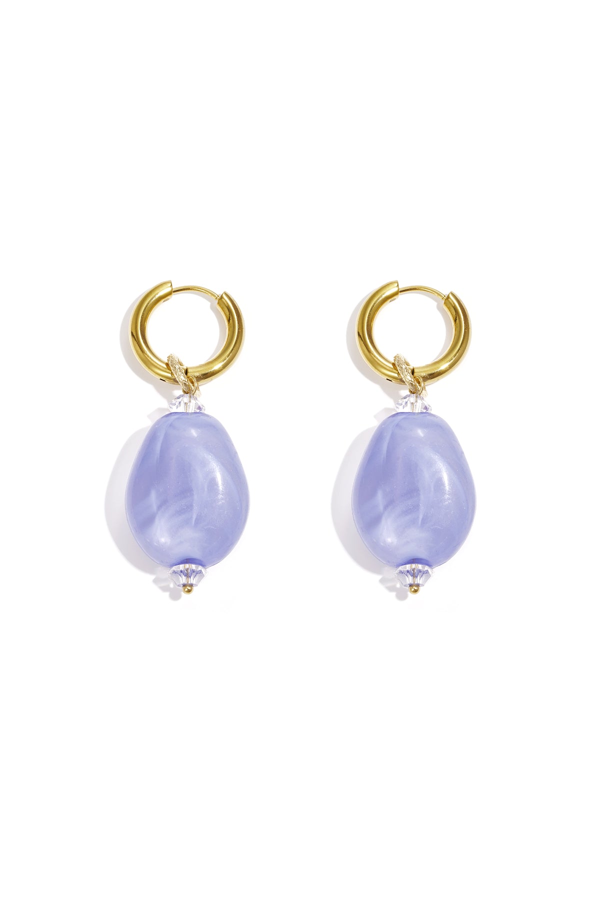 Pair of gold hoop earrings with violet cloudy resin beads on white background