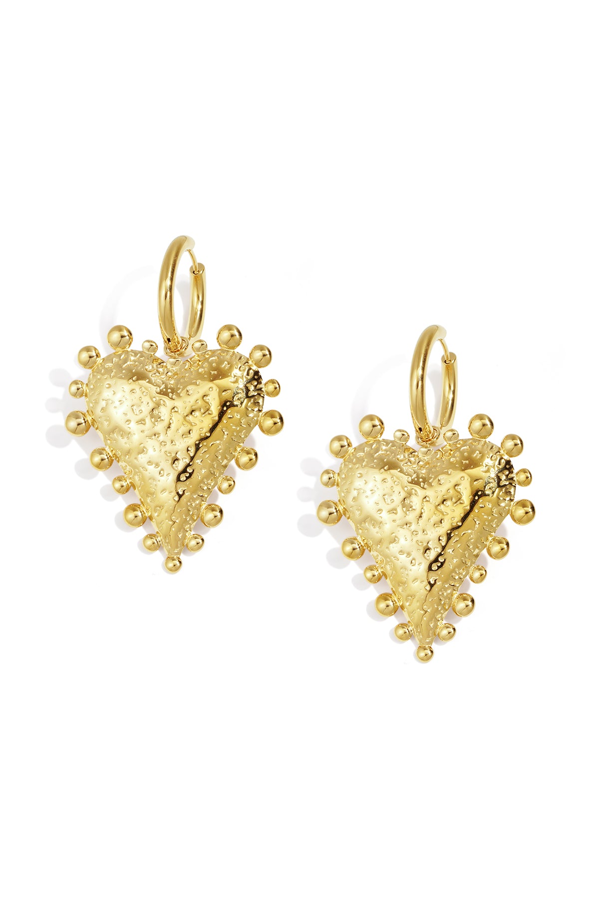 Close-up image of textured gold heart-shaped hoop earrings with rounded stud detailing on a white background