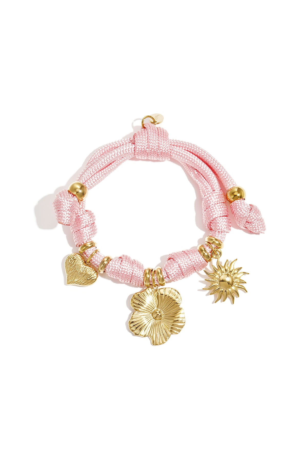 Pink rope charm bracelet with gold heart, flower, and sun charms on a white background