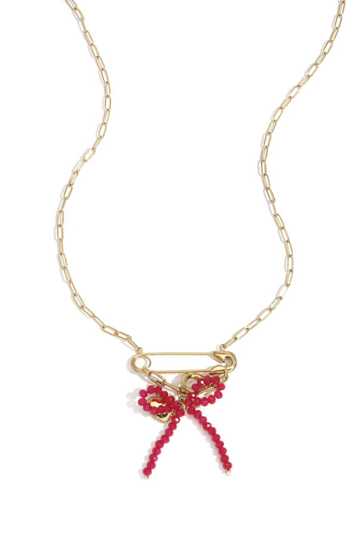 Gold-tone safety pin necklace with red bead bow and heart and moon charms displayed on white background