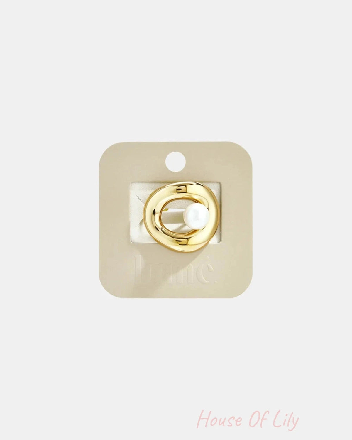 Gold organic-shaped ring with central pearl, displayed on beige card.