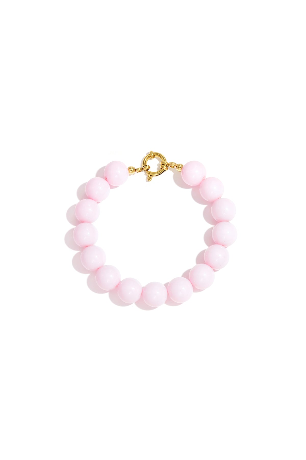 Light pink resin bead bracelet with gold toggle clasp on white background