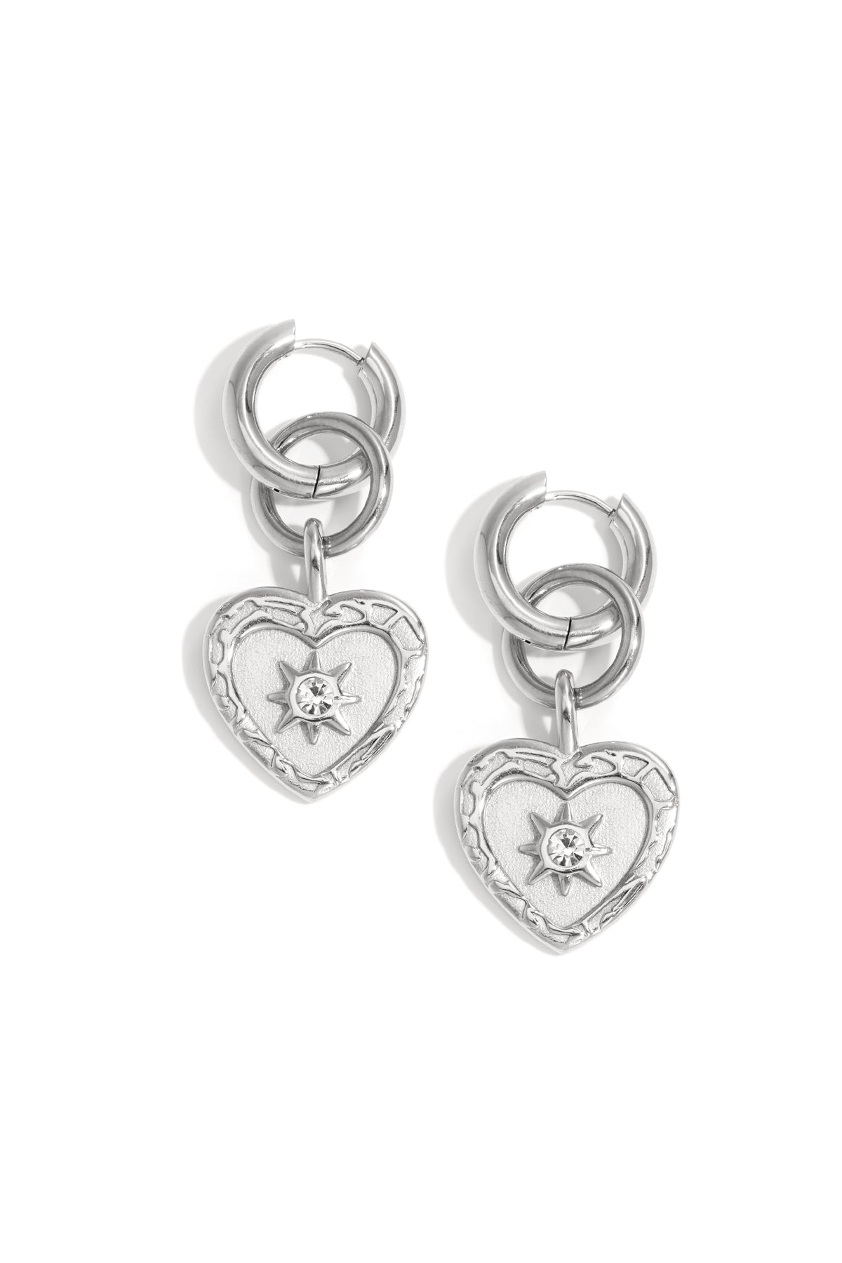 Silver heart charm drop earrings featuring interlocking hoops with rhinestone star detail on white background