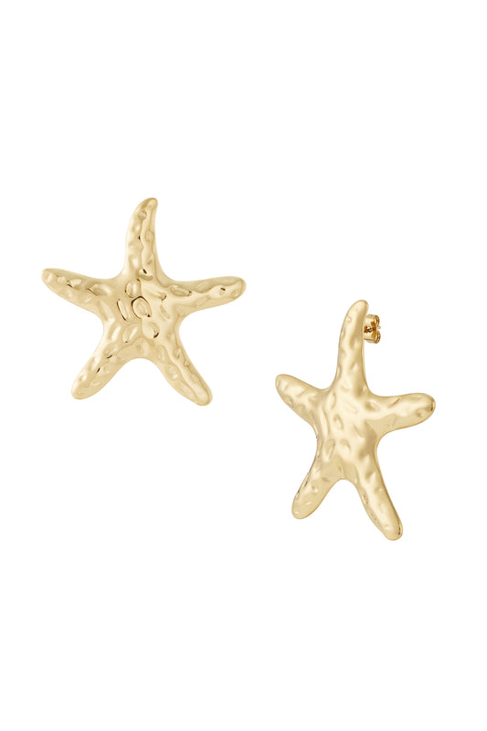 Pair of hammered gold plated starfish stud earrings on white background