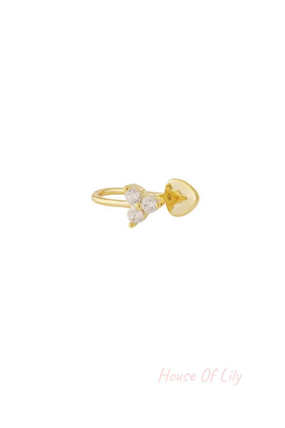 Gold nose cuff with three clear zircon stones in triangular shape isolated on white background