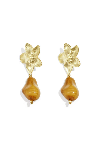 Pair of gold-tone flower drop earrings with amber organic acrylic bead on white background