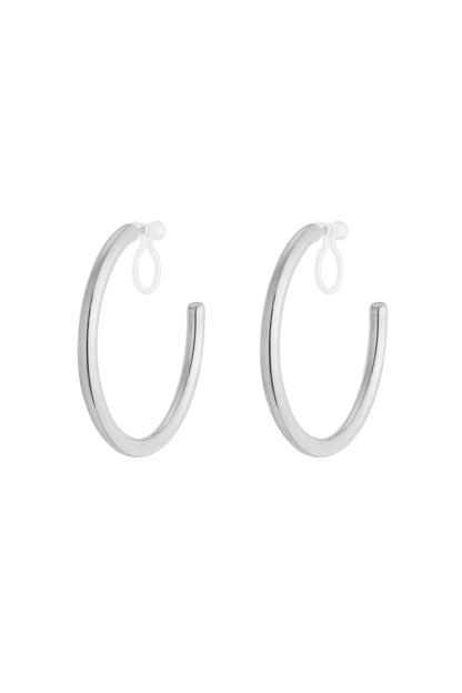Pair of polished silver-tone clip-on hoop earrings with clear silicone loops on white background