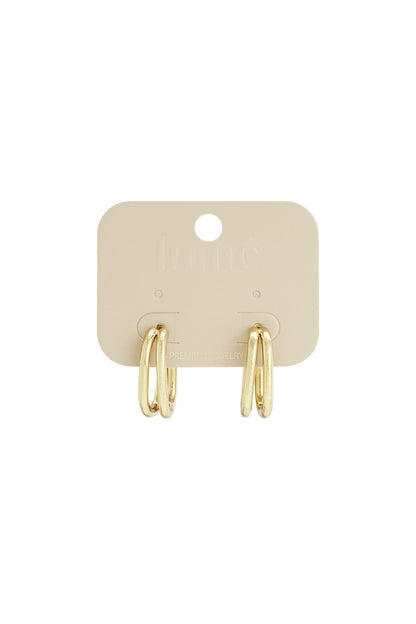 Main Character Energy gold-toned double-layered oval hoop earrings on a branded display card.