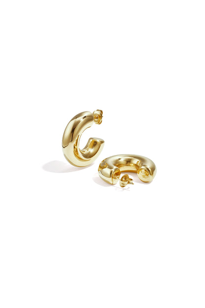 Pair of chunky gold hoop earrings with smooth polished finish displayed on white background