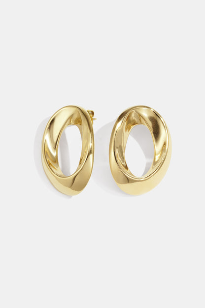 Pair of polished gold-tone twisted oval hoop earrings on white background