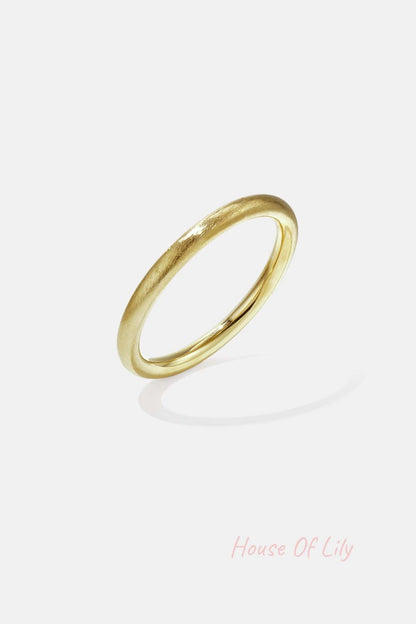 Single matte gold bangle with smooth circular design isolated on white background