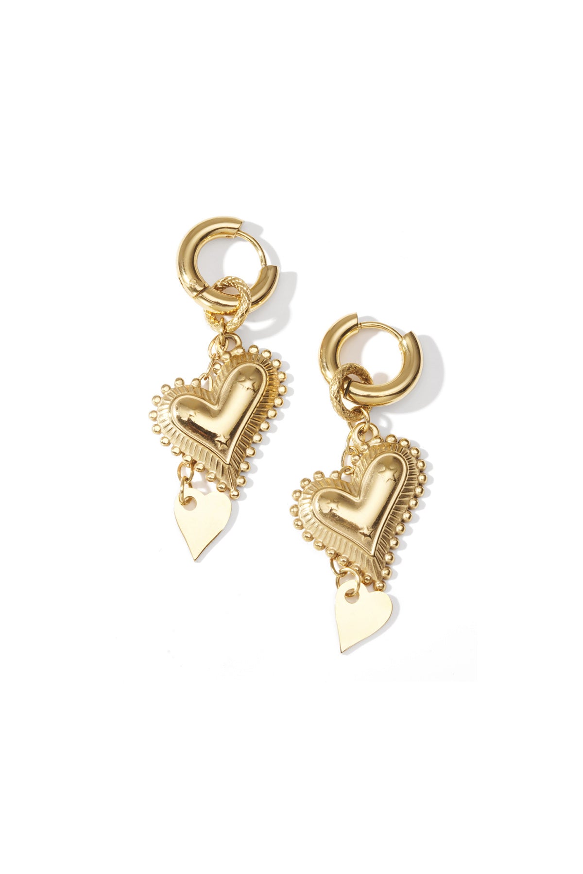 Gold heart drop earrings with embossed larger heart and smaller dangling heart on a white background