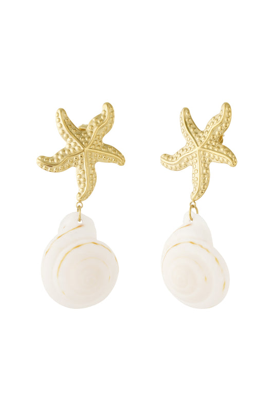Pair of gold starfish drop earrings with dangling white spiral shells displayed against white background