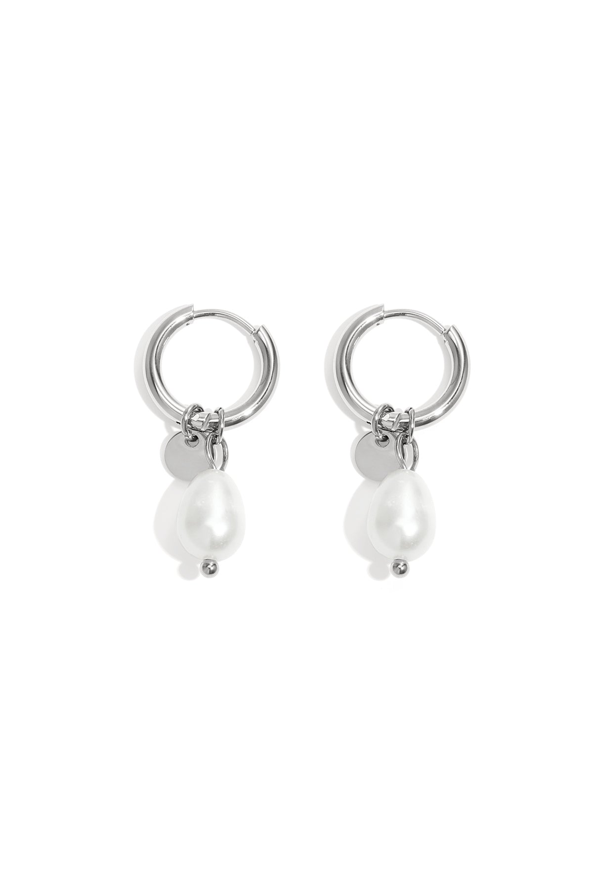 Pair of silver hoop earrings with dangling irregular-shaped white pearls and small silver discs on white background