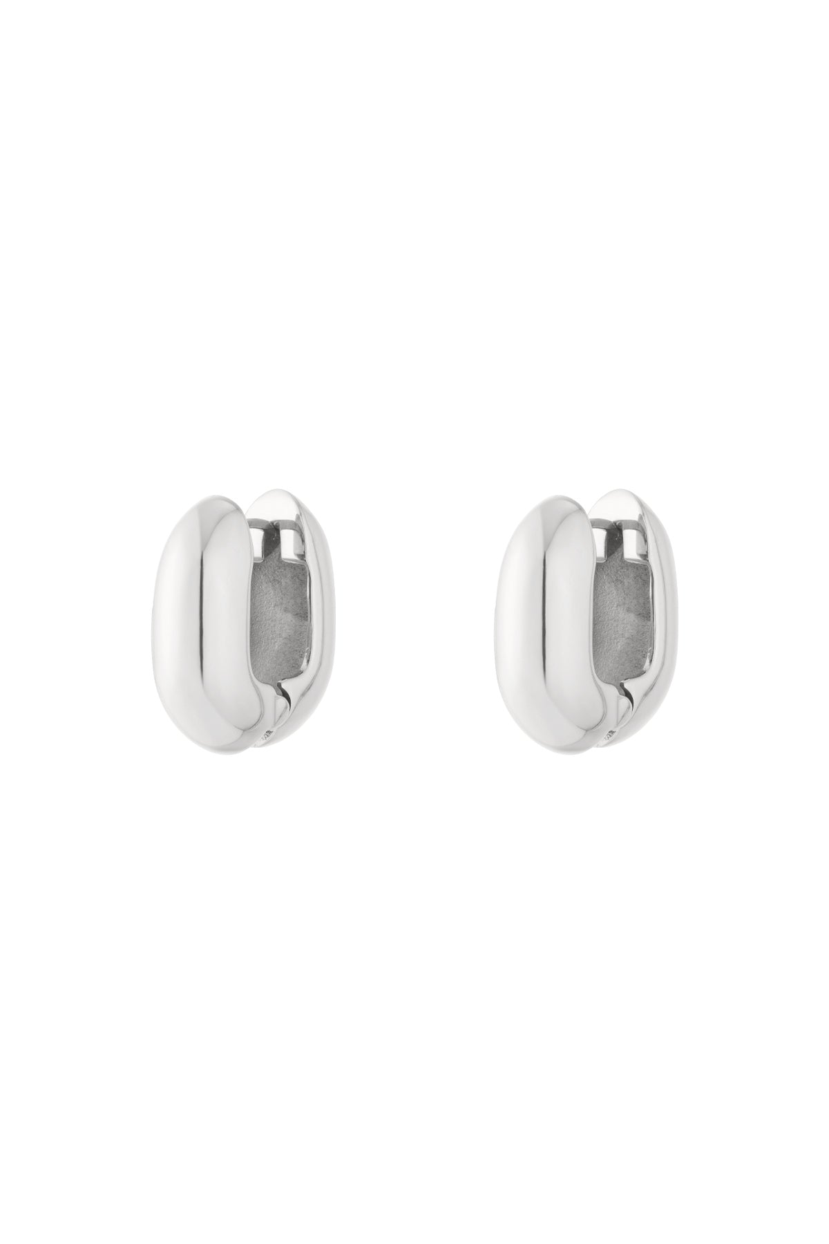 Pair of chunky oval hoop earrings in polished silver finish isolated on white background