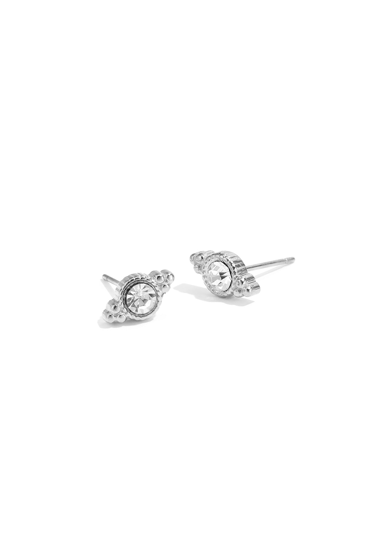 Pair of silver-toned crystal stud earrings with irregular shaped design on white background