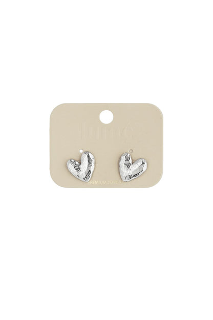 Silver Puffy Heart Hype stud earrings featuring a textured, metallic finish on a display card.
