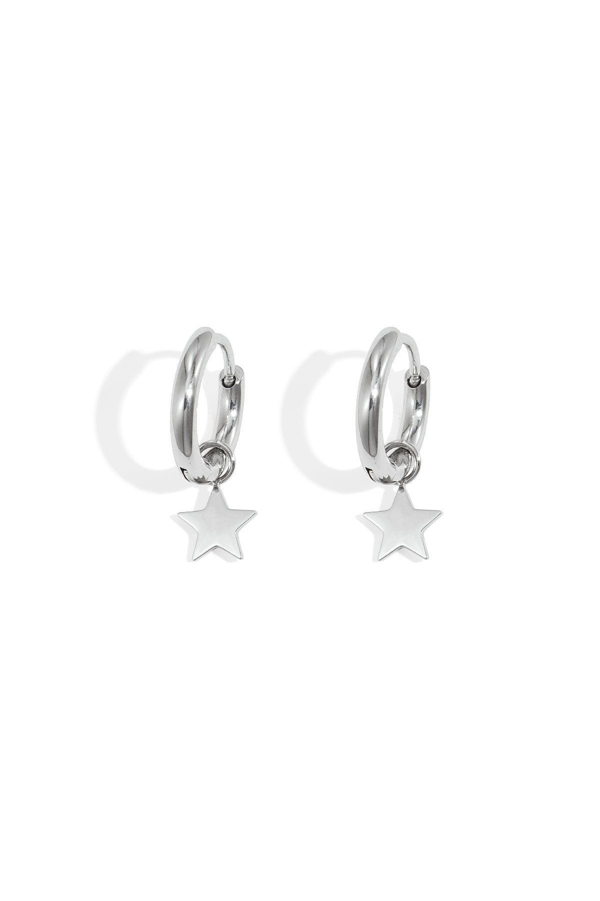 Pair of silver hoop earrings with dangling star charms on white background