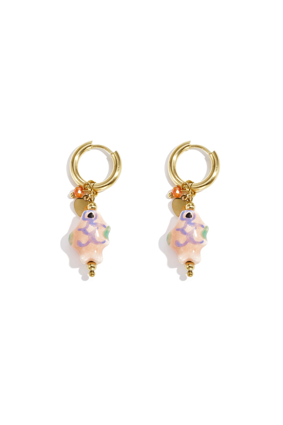 Pair of gold-tone hoop earrings with pastel pink ceramic fish charms, accented with small beads and charms on white background
