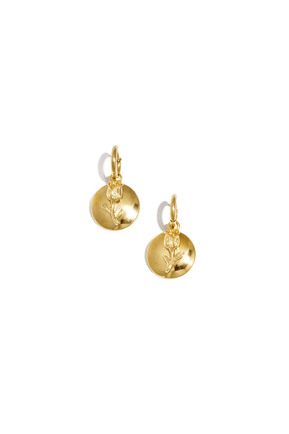Pair of gold-tone drop earrings with a textured rose on a circular disc, shown against white background