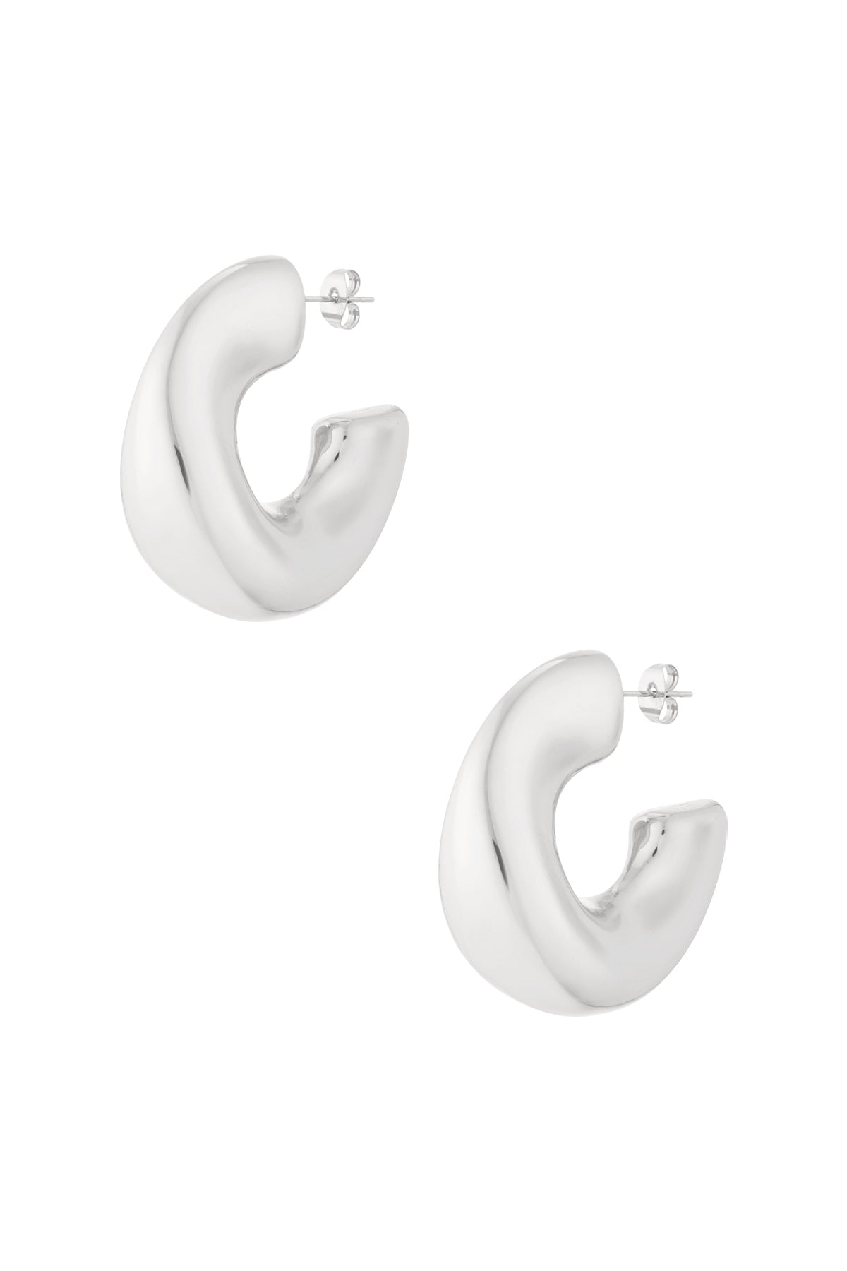 Pair of chunky sculpted hoop earrings in polished silver finish isolated on white background
