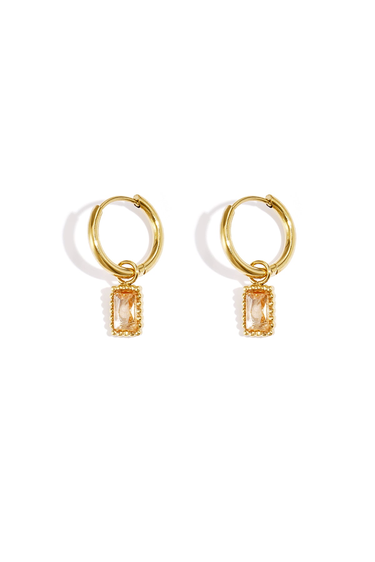 Pair of gold hoop earrings with champagne-coloured rectangular gemstone charms on a white background