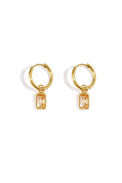 Pair of gold hoop earrings with champagne-coloured rectangular gemstone charms on a white background