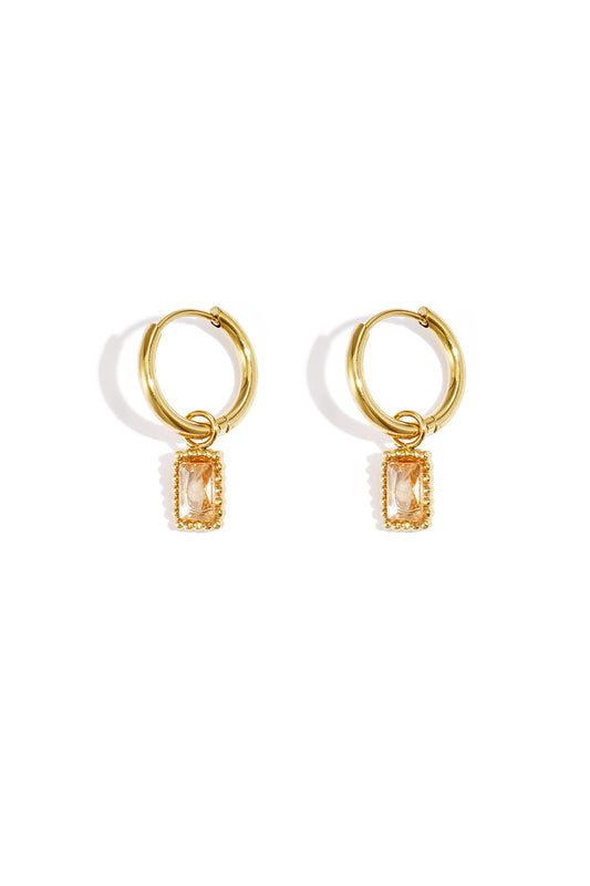 Pair of gold hoop earrings with champagne-coloured rectangular gemstone charms on a white background
