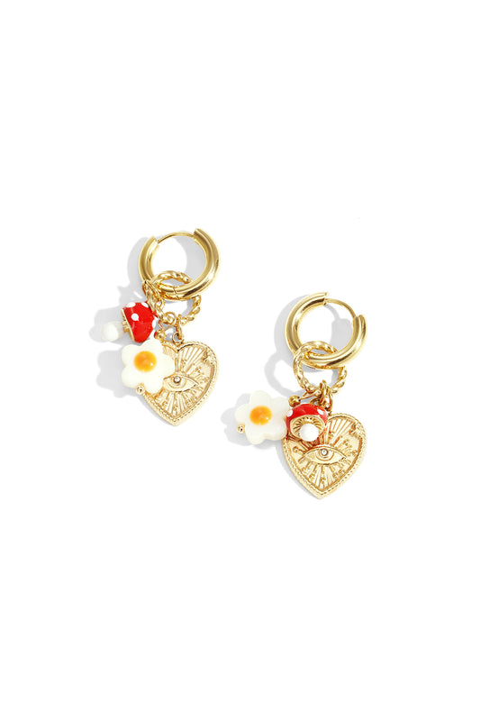 Pair of gold-tone hoop drop earrings with charms of a red polka dot mushroom, white flower, and heart with engraved eye detail