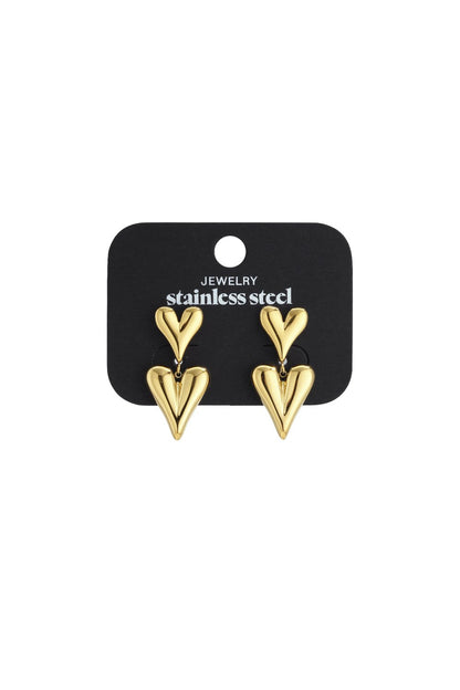Gold-tone double heart drop earrings on a stainless steel jewelry card. Smooth, puffy heart shapes in a modern style.