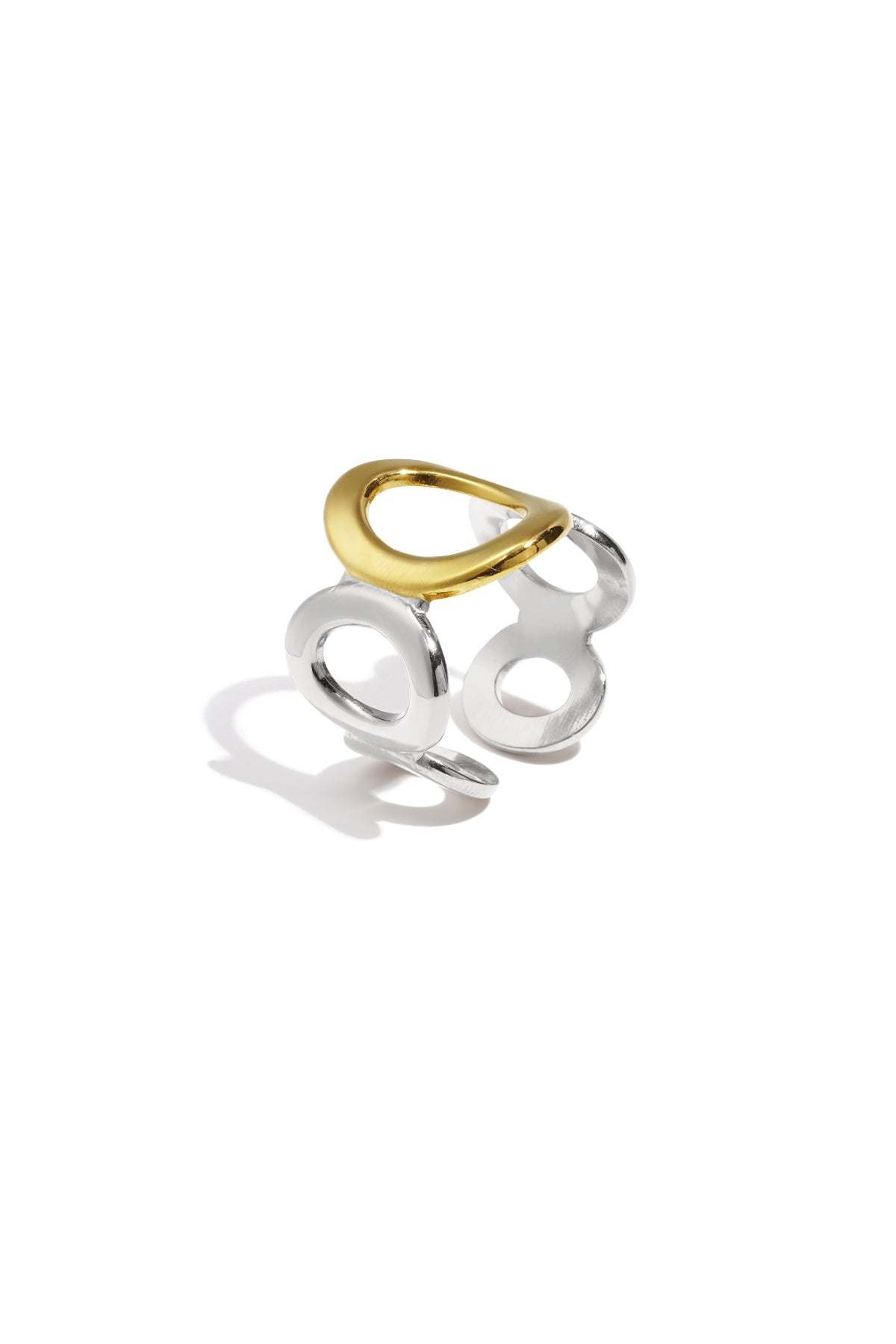 Gold and silver two-tone open circle ring with oval shapes on white background showing design details