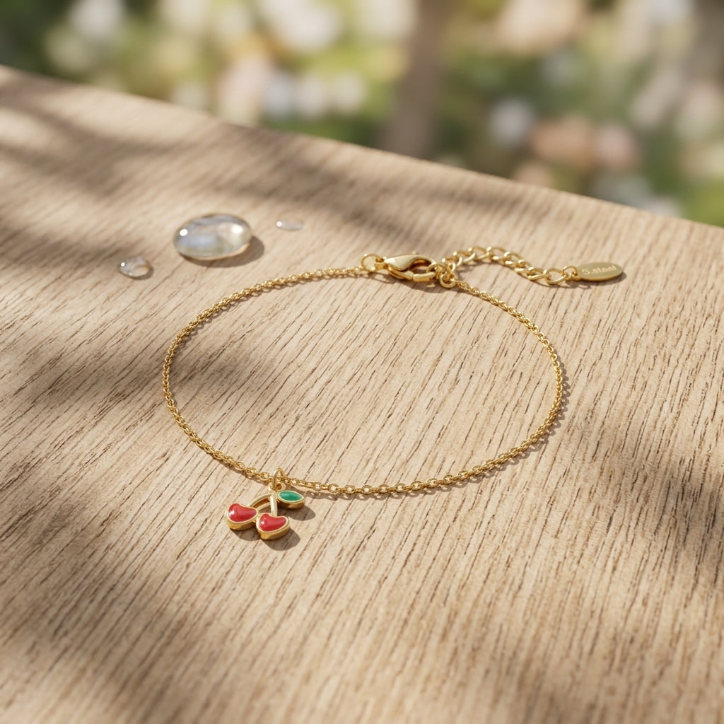 Close-up of the cherry love bracelet made of stainless steel with lobster clasp resting on textured wooden surface, highlighting its polished finish and delicate links.