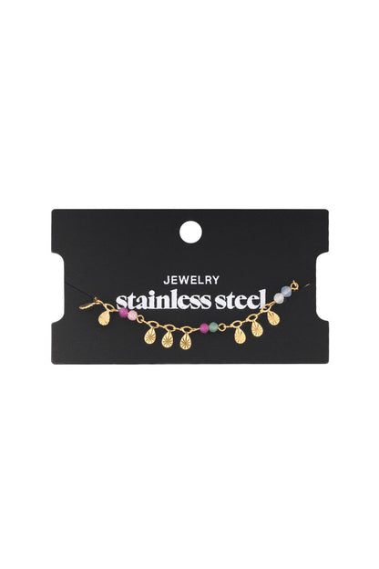 Golden Hour Glow gold stainless steel charm bracelet featuring colorful beads and textured, sunburst-shaped pendants.