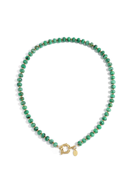 Close-up of a pink stone beaded necklace with gold beads and toggle clasp