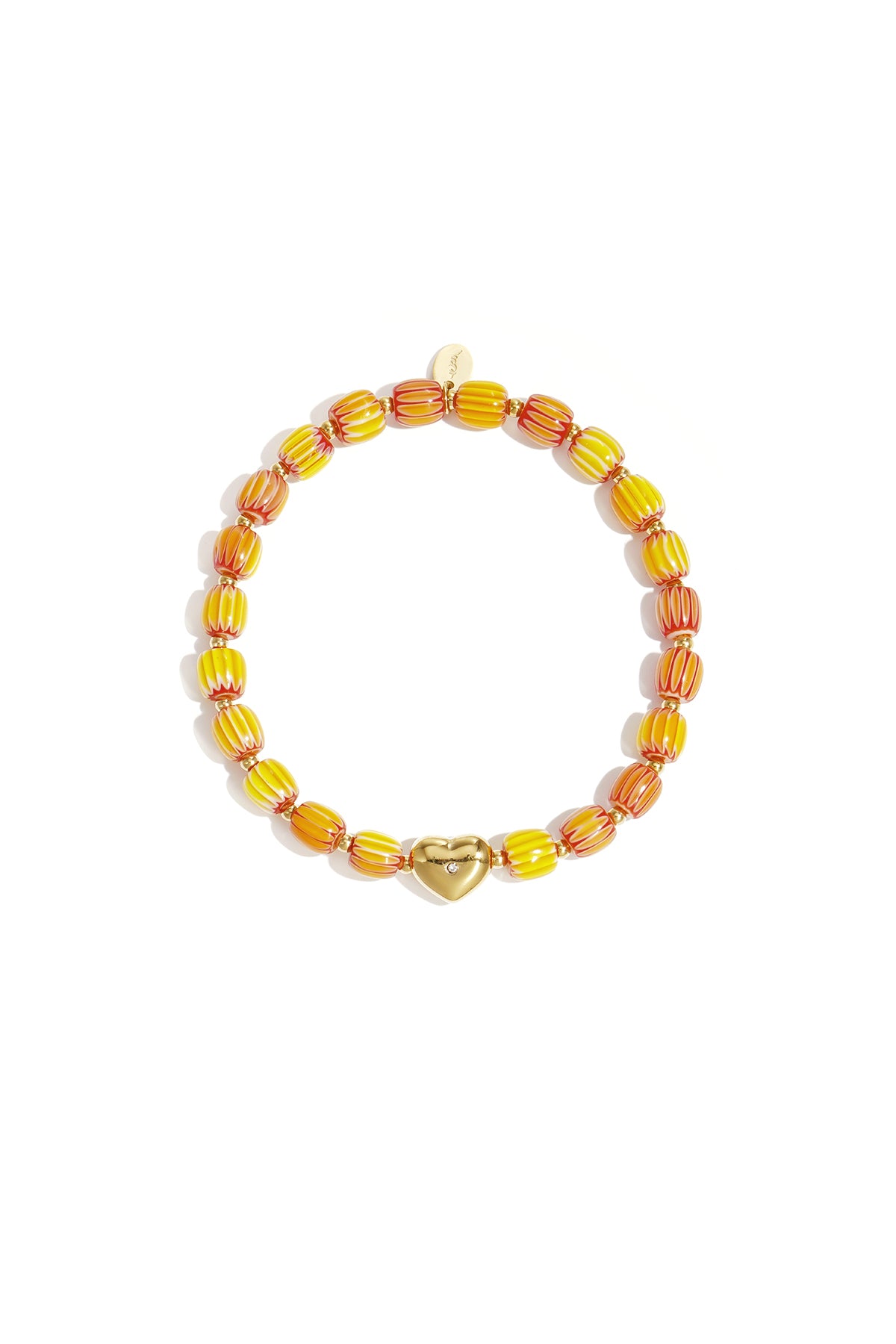 Yellow and orange striped beaded bracelet with gold heart charm laid flat on white background
