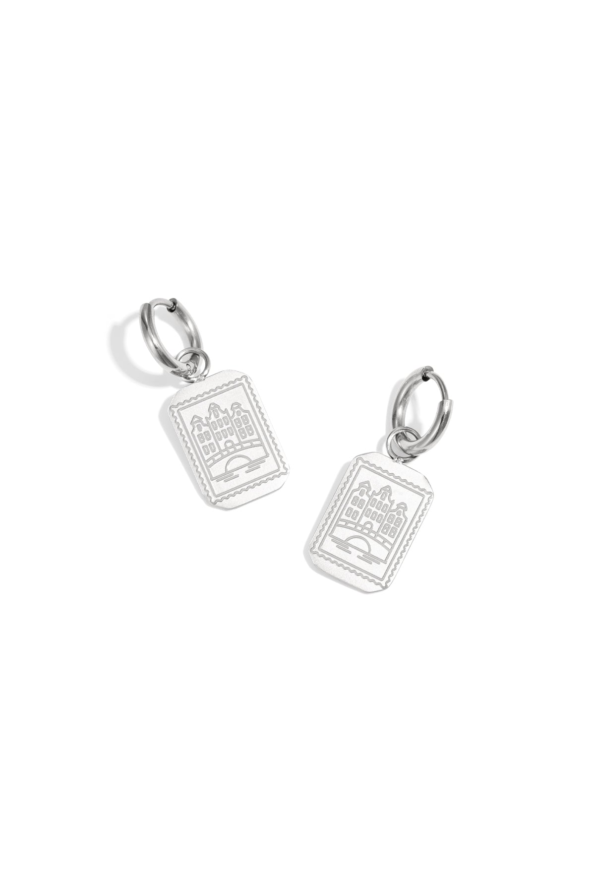 Pair of silver drop earrings with rectangular Amsterdam canal house pendants on a white background.