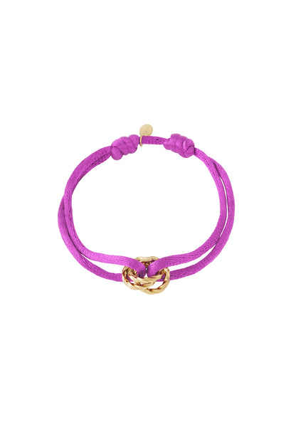 Brown knot charm bracelet with gold-plated twisted knot pendant on white background