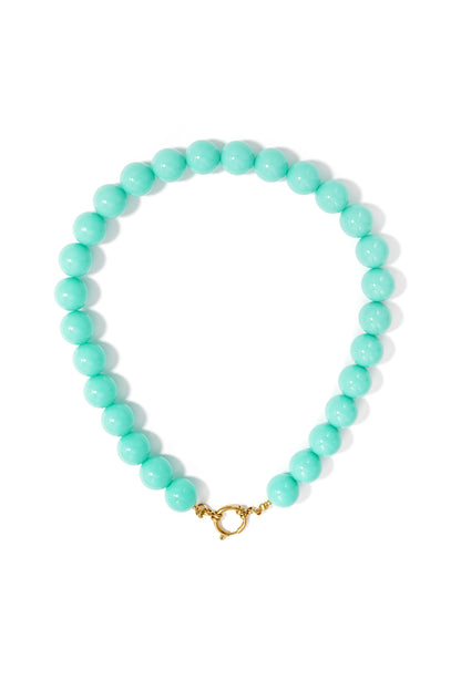 Chunky necklace made of round, turquoise resin beads with a gold-tone metal spring ring clasp at the front.