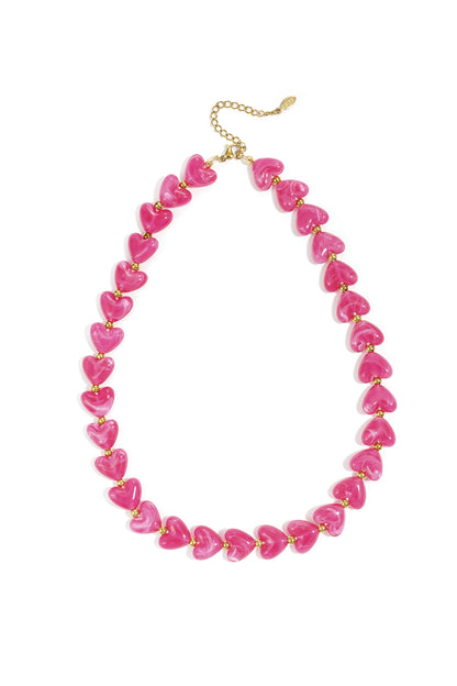 Turquoise marbled heart bead necklace with gold spacers on white background