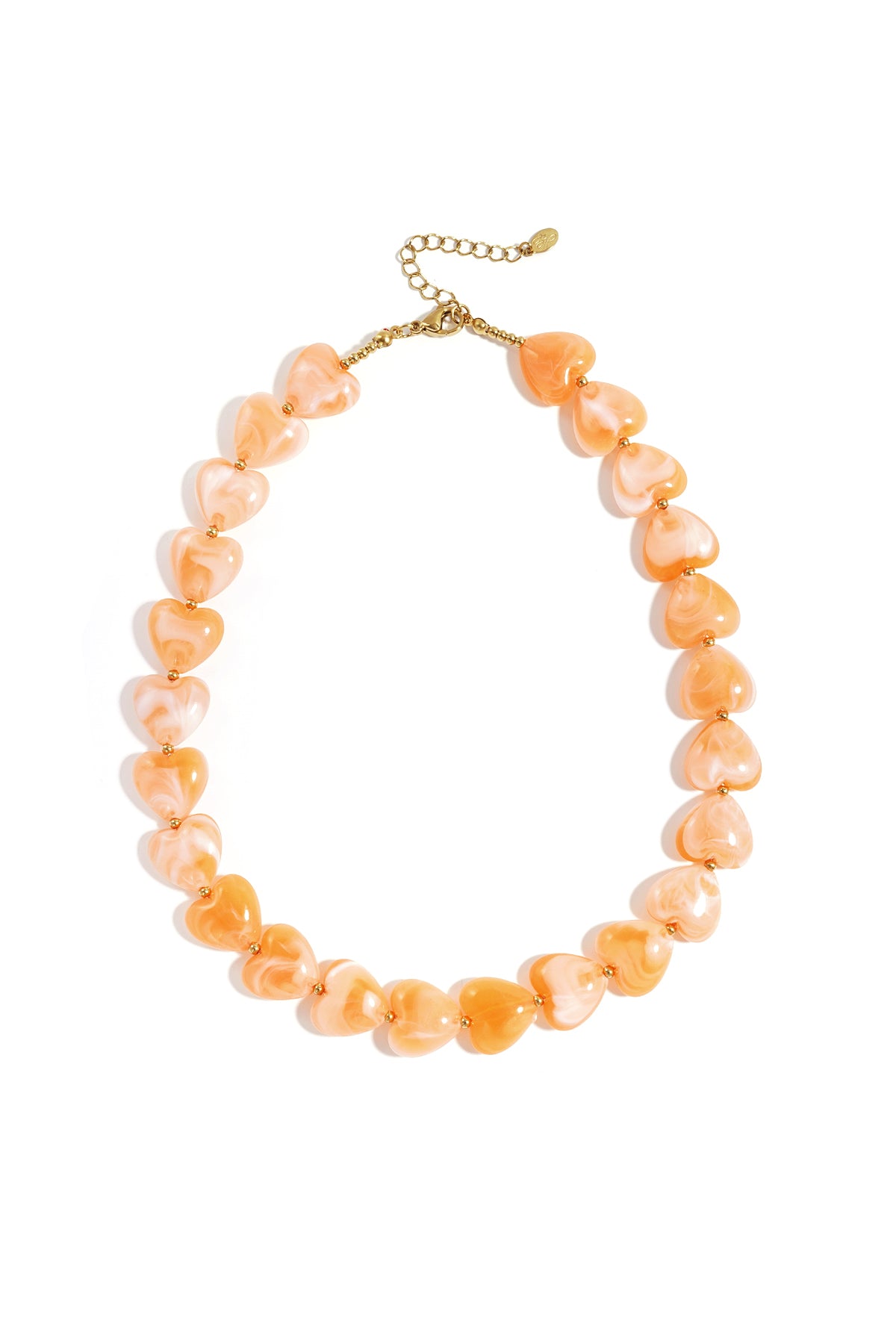 Peach coral heart-shaped bead necklace with gold-tone spacers on white background