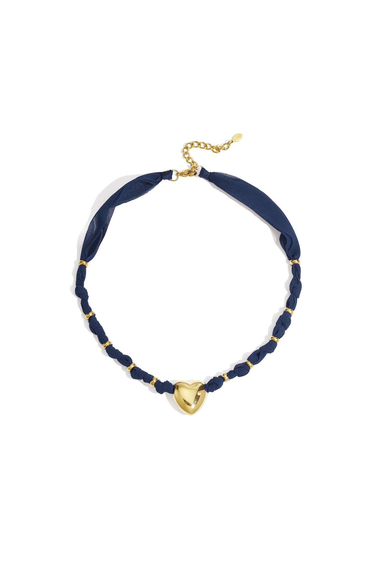 Gold heart pendant necklace with navy braided fabric and gold accents on white background