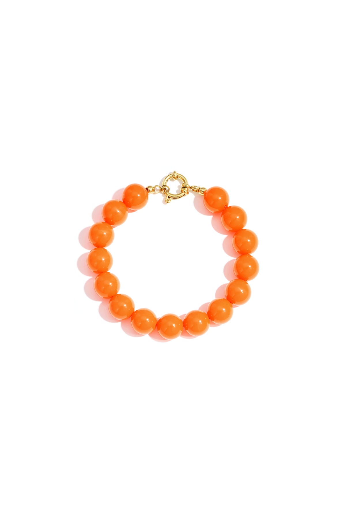 Bright orange resin bead bracelet with gold toggle clasp on white background
