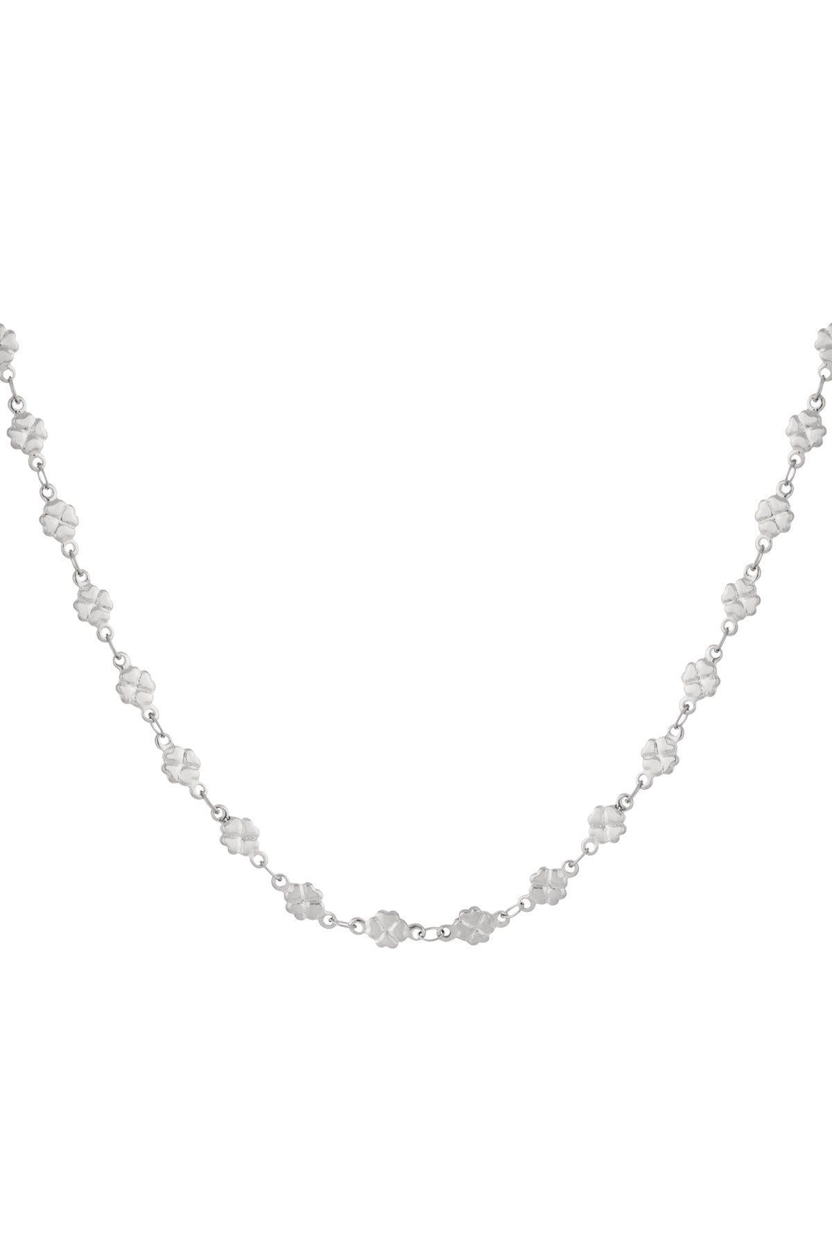 Close-up of a silver-colored necklace with small clover-shaped links linked by fine chain against a white background