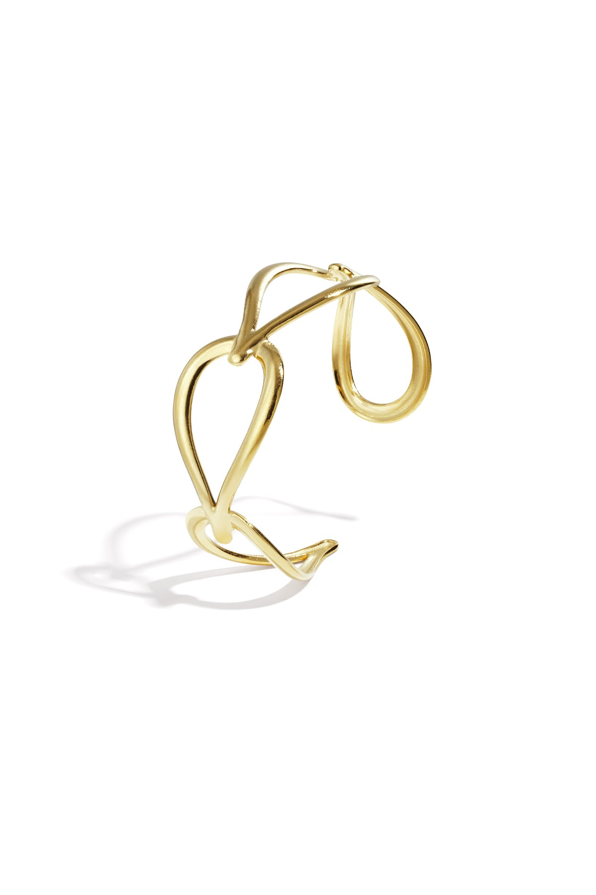 Gold sculptural open loop cuff bracelet isolated on white background